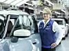 BMW-Leipzig Werkleiterin Petra Peterhänsel neben einem Fahrzeug in der Endmontage