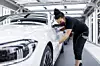 Eine Mitarbeiterin von Daimler überprüft in der Factory 56 den Lack einer S-Klasse.