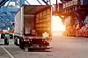 Cargo truck in the port. Heavy-duty commercial vehicle. Semitrailer during loading of the cargo. Modern semi-trailer trucks on the highway. Commercial vehicle for shipping and post delivery.
