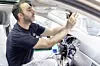 Assembly Wolfsburg plant: An employee installs the rearview mirr