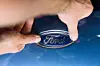 Fertigung des neuen Ford Focus: Ein Ford-Mitarbeiter bringt in der Bumper-Vormontage das Ford-Logo an.