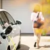 Close up of a electric car charger with female silhouette in the